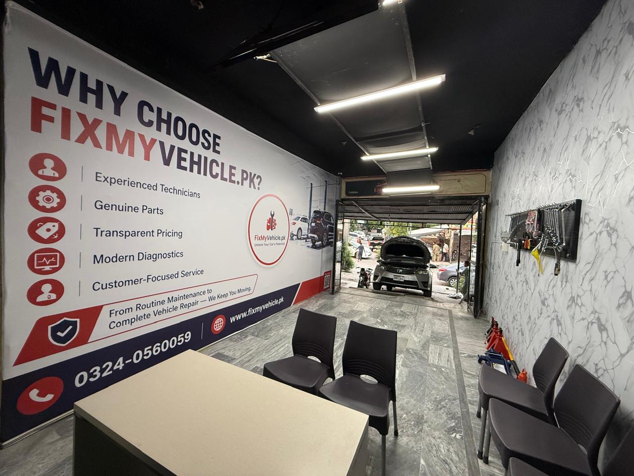 FixMyVehicle workshop interior with customer reception and an active service bay in Islamabad